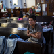 A Central American migrant wakes up on Nov. 4 inside a church in Puebla that opened its doors to members of the caravan who splintered off the main group in order to reach Mexico City faster.